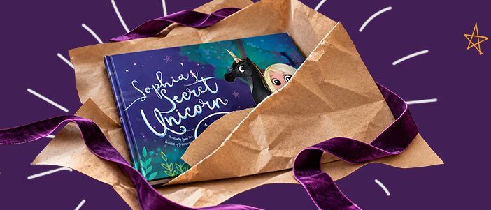 A personalised book unwrapped from brown paper and purple ribbon